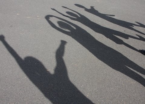 Shadows of children on pavement