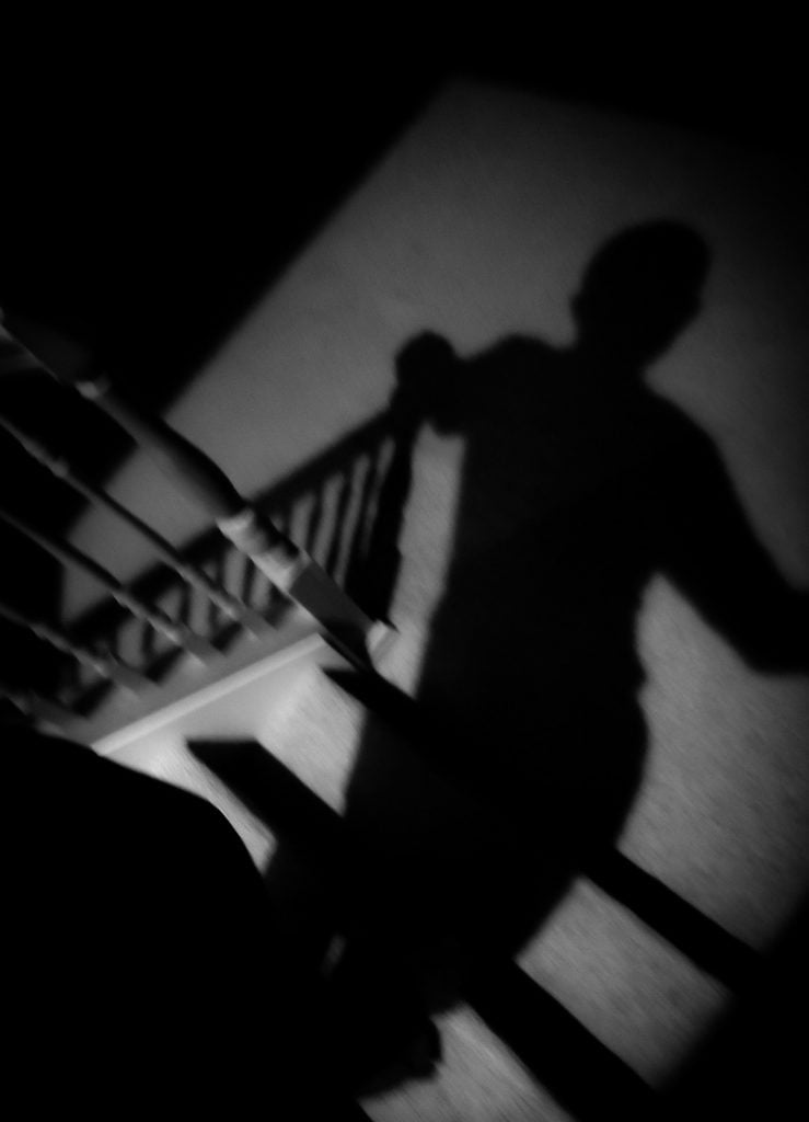 A shadow of a person on the stairs