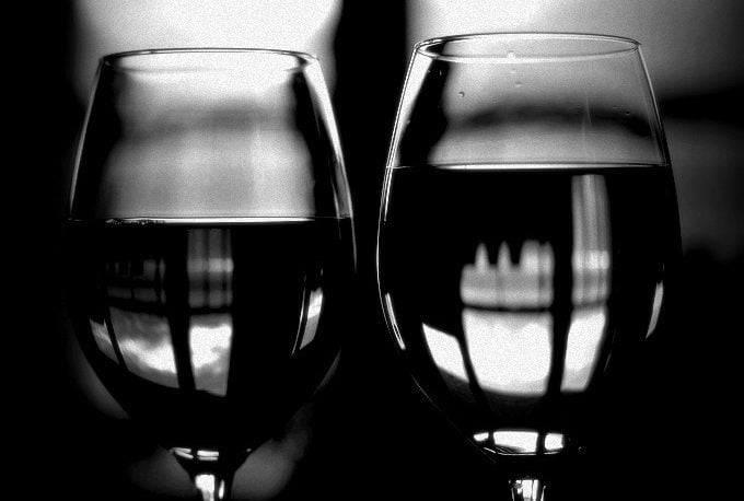 A pair of wineglasses with liquid in them