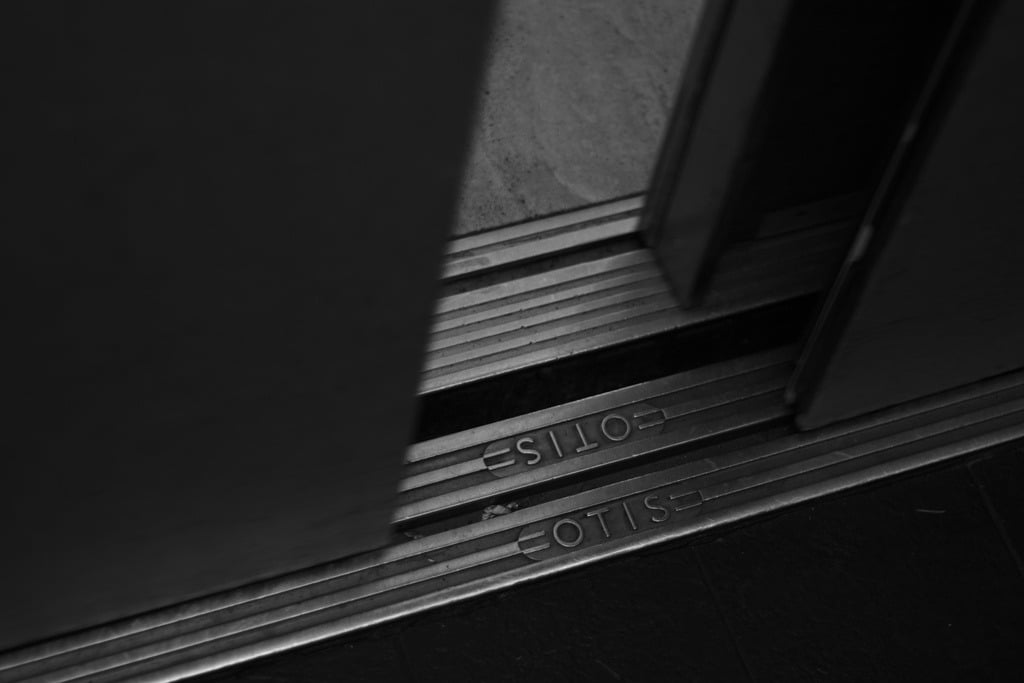 Close-up on the door of an elevator opening, right where it meets the floor