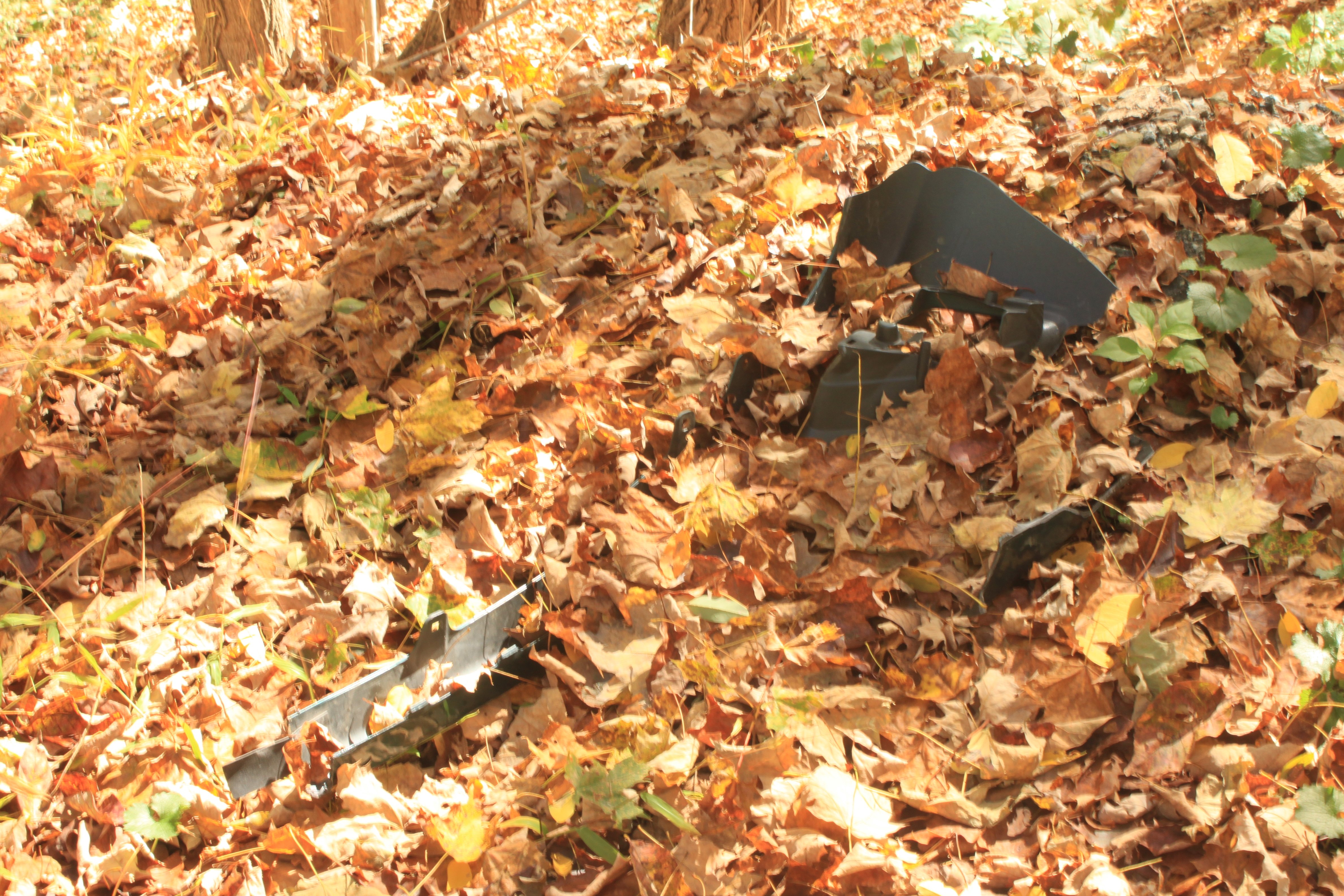 A fender from a car lying in the woods