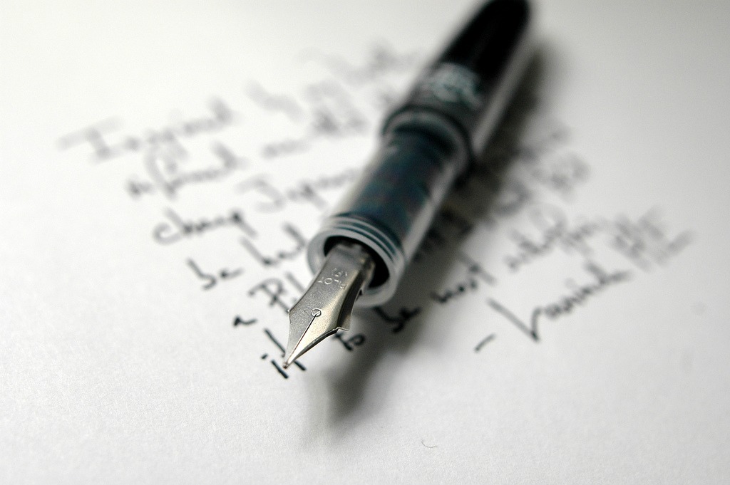 A fountain pen atop a handwritten letter