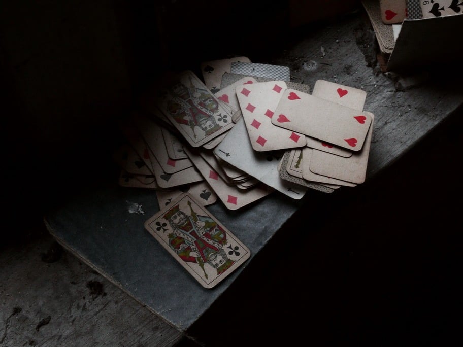 Old playing cards strewn across a table