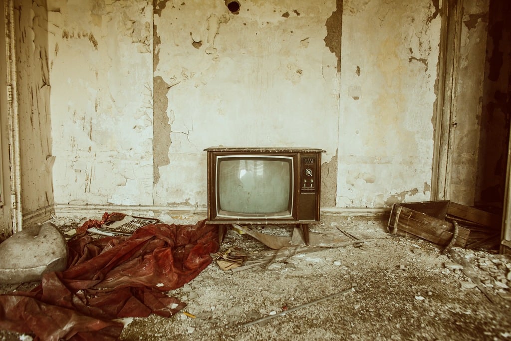A vintage television in an abandoned room