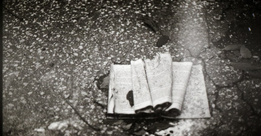 A battered book lying on the ground