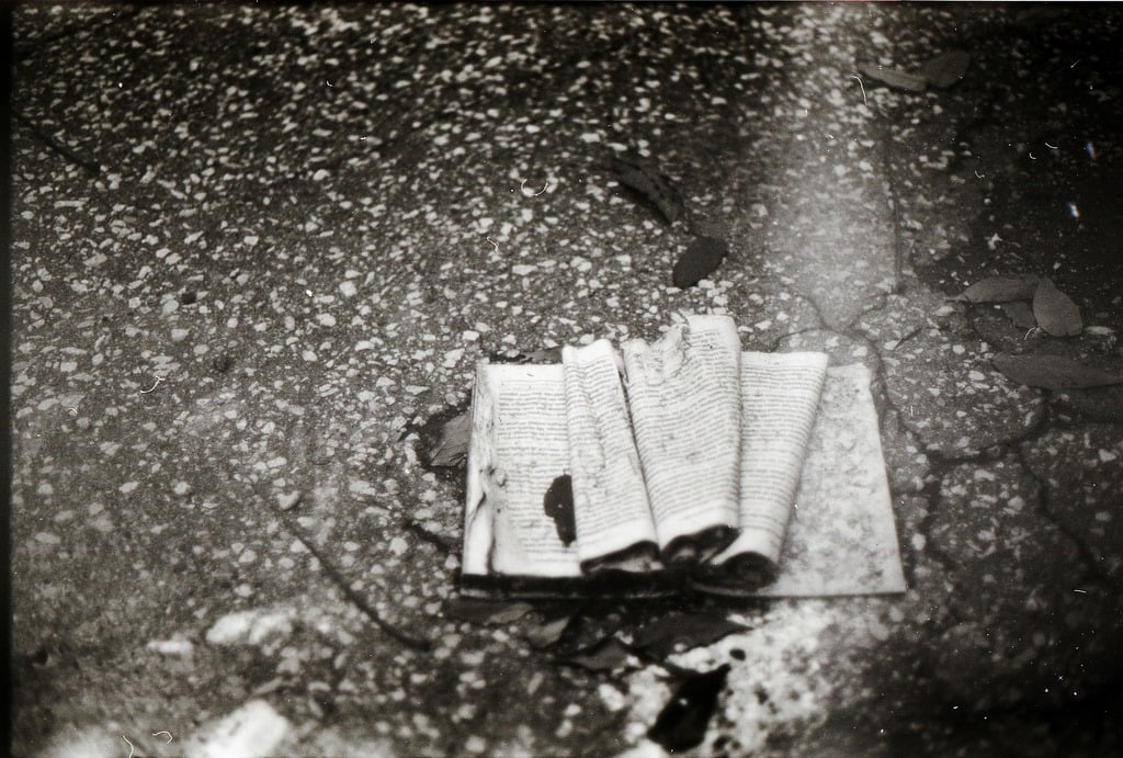 A battered book lying on the ground