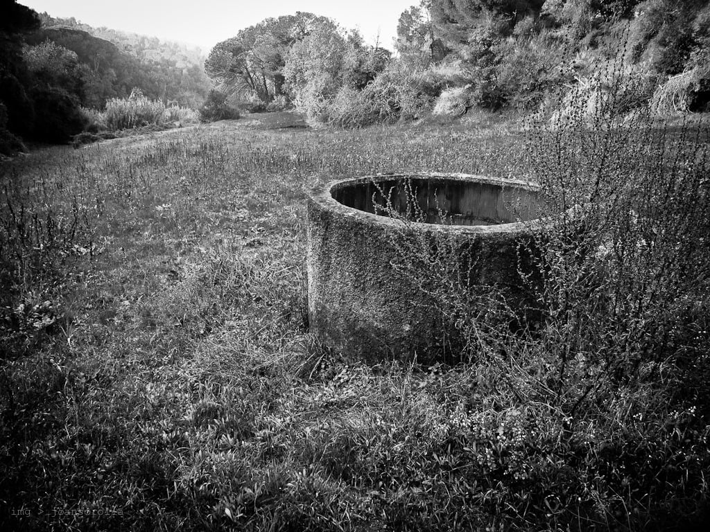 A stone well in a field