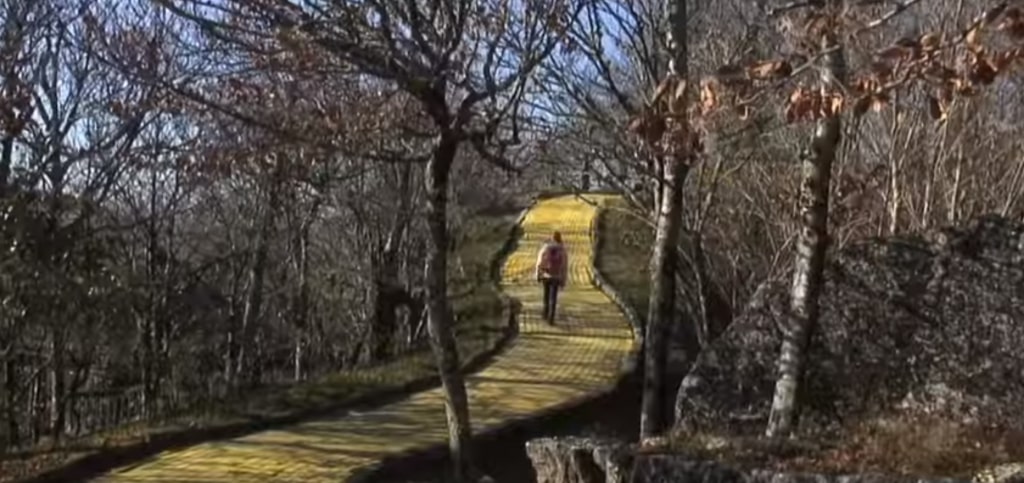 A person walking down the Yellow Brick Road at the pseudo-abandoned Wizard Of Oz theme park