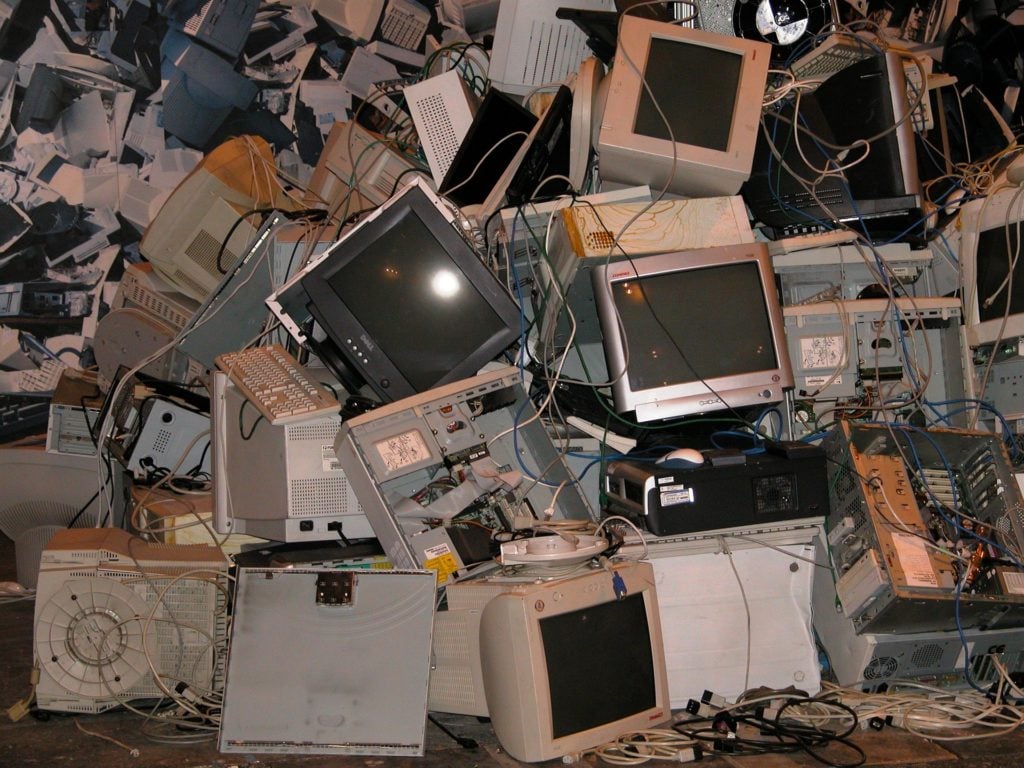 A pile of old computer monitors