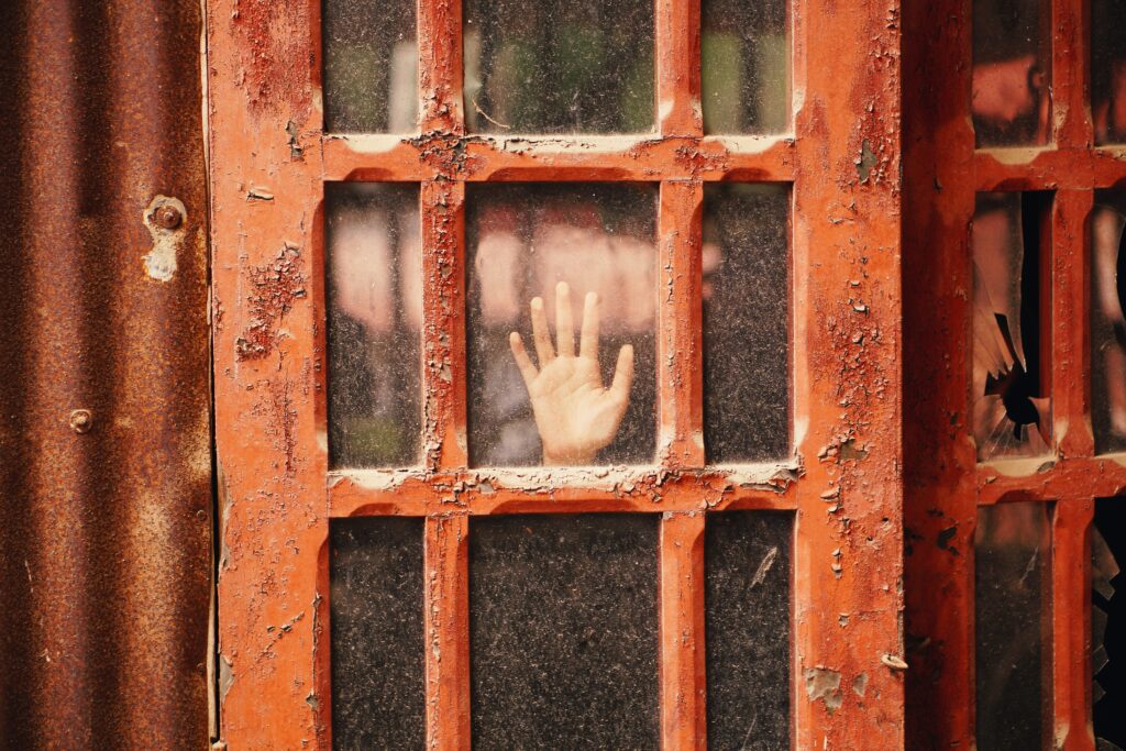 A hand at a red window