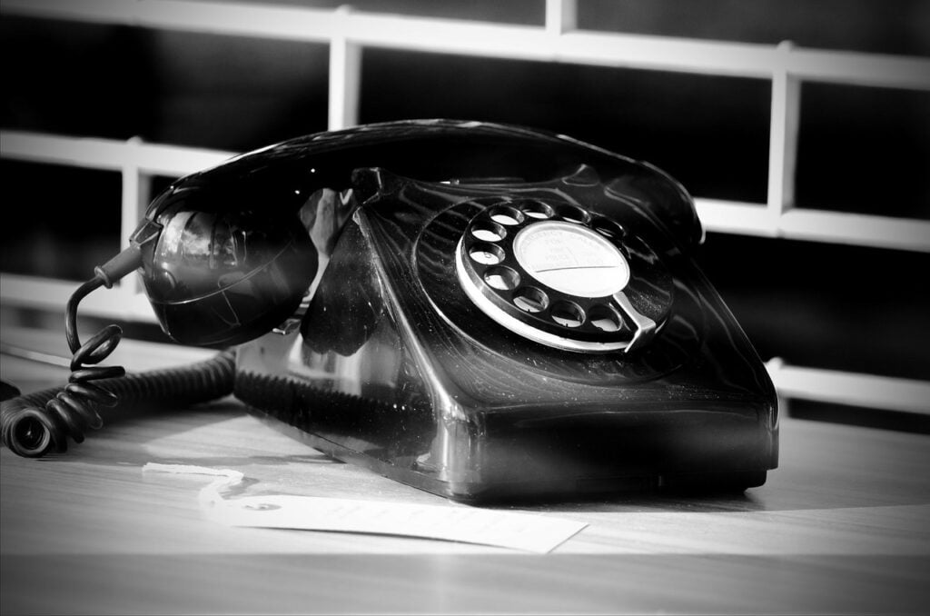An old, black rotary telephone