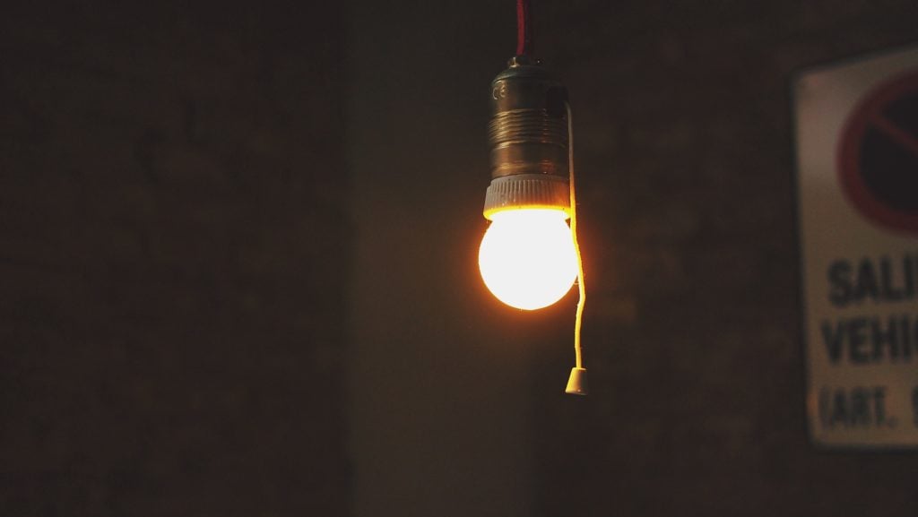 A bare lightbulb, lit