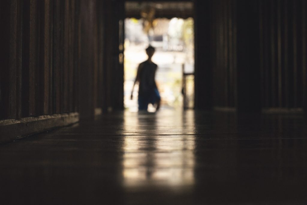 A shadowy figure in a doorway