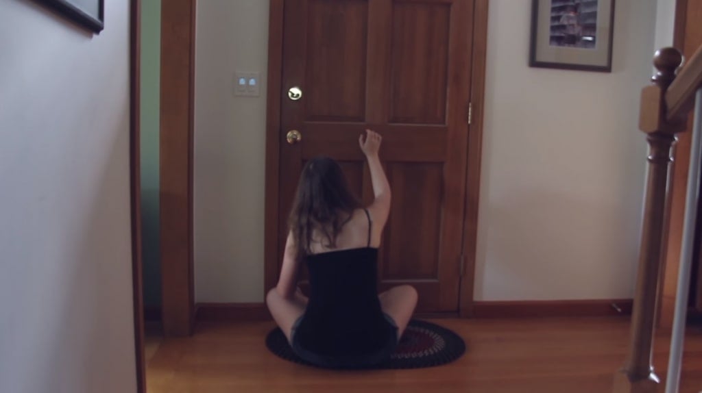 Screenshot from Hi I'm Mary Mary showing Mary sitting on the floor in front of a closed door
