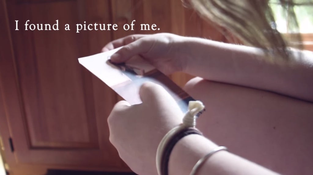 Screenshot from Hi I'm Mary Mary showing Mary's hands holding a picture of herself