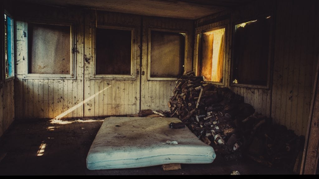 An abandoned bed in an abandoned room