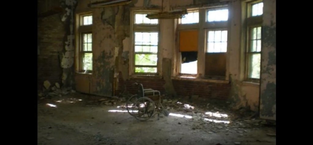 A wheelchair in a room in the abandoned ruins of the Pennhurst State School and Hospital