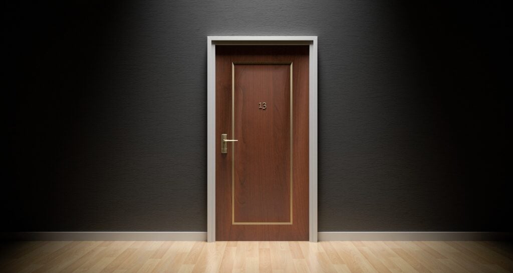 A brown door in a black wall