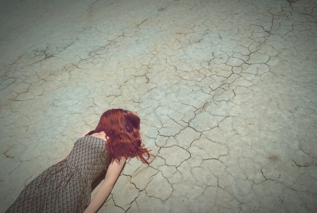 A redheaded woman lying on the ground