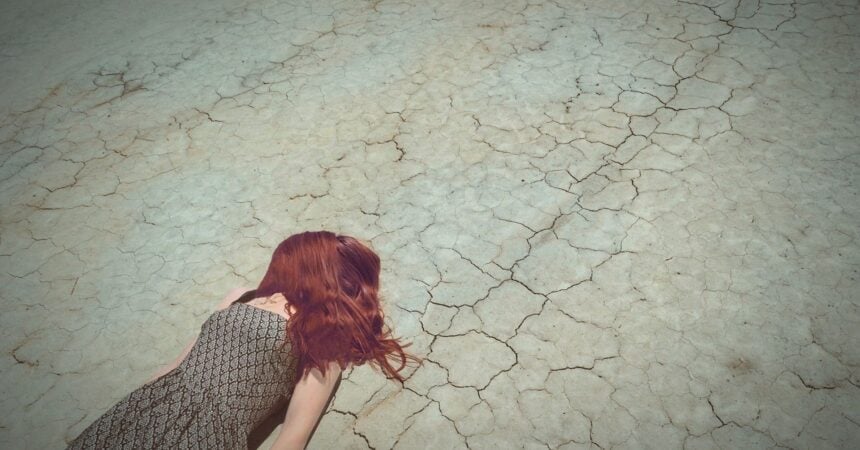 A redheaded woman lying on the ground