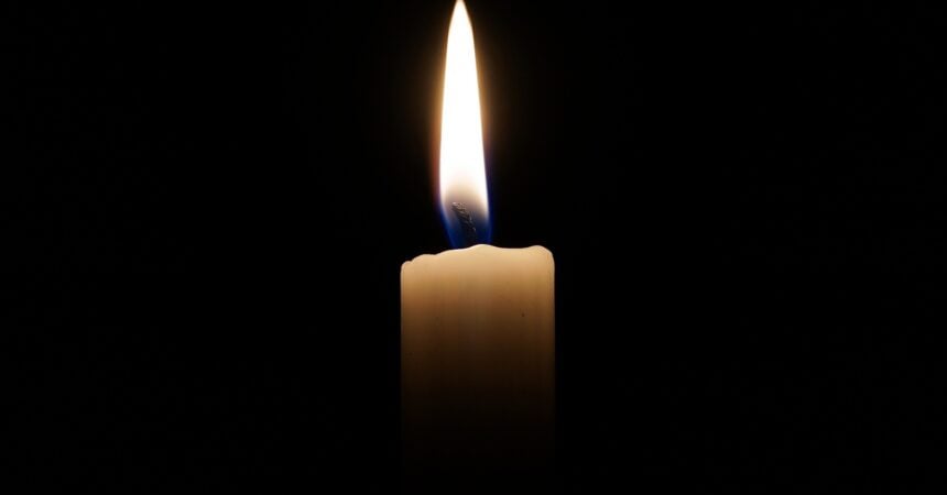A candle burning in a dark room