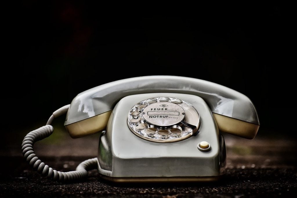 An old, white rotary phone