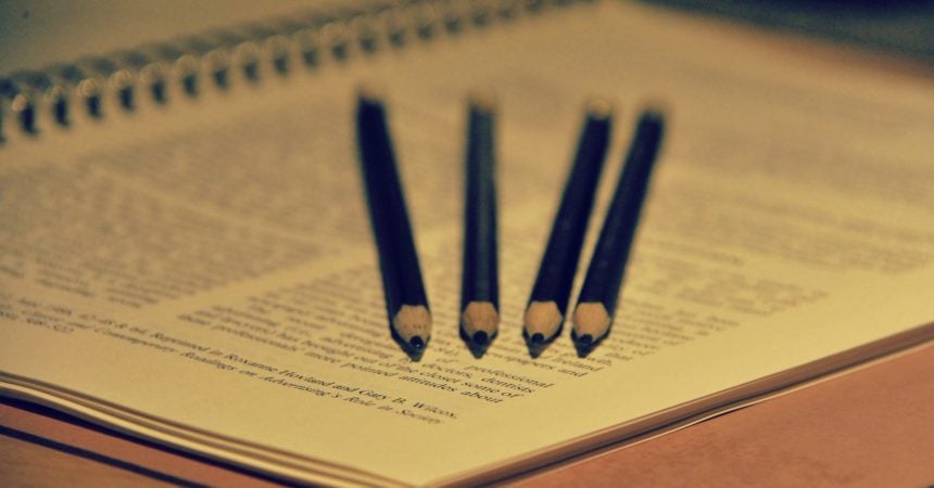 Pencils lined up on a notebook