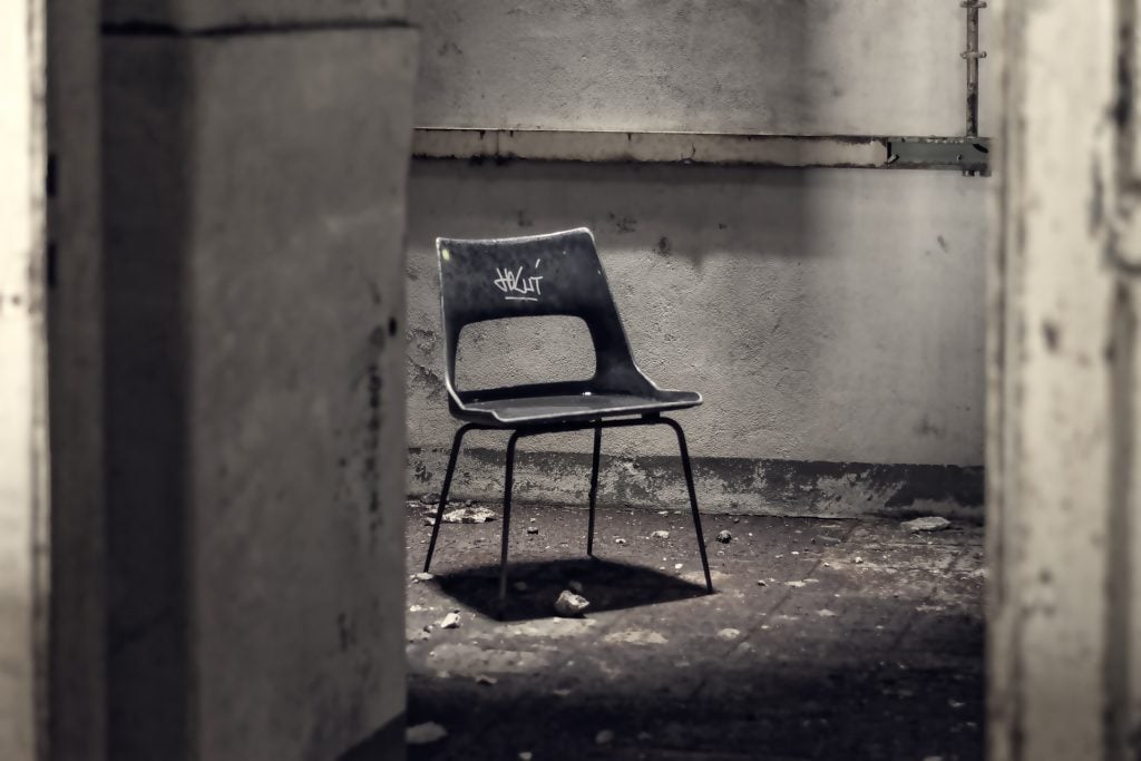 An abandoned chair alone in a room