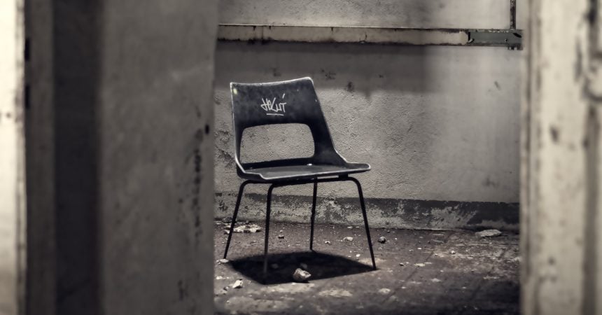 An abandoned chair alone in a room