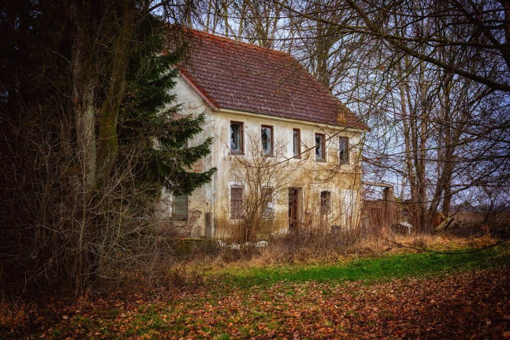 A white house in a clearing in the woods