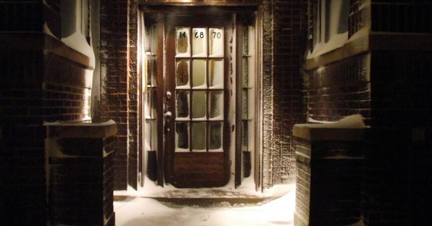 The exterior of a door in a building in the snow