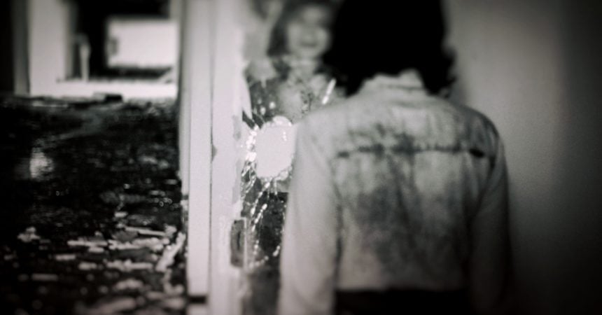 A woman and her reflection, blurry in a mirror