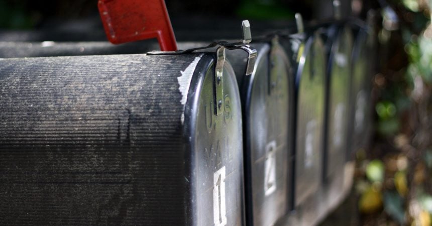 A row of mailboxes, one with a red flag up