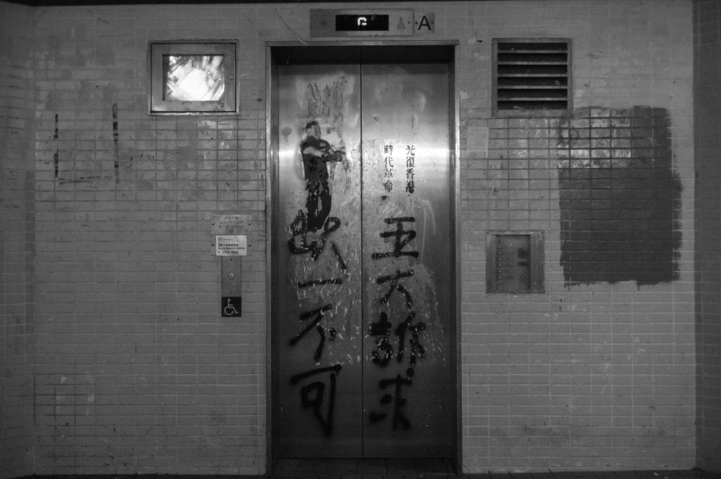An elevator covered with graffiti