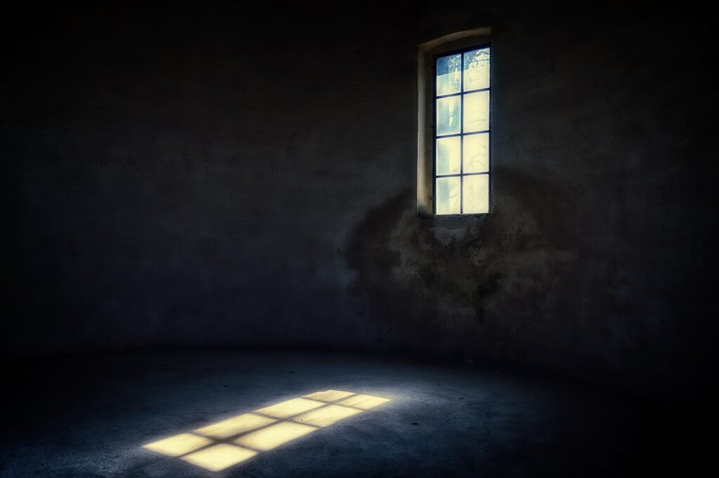 A window letting sunlight into a dark room