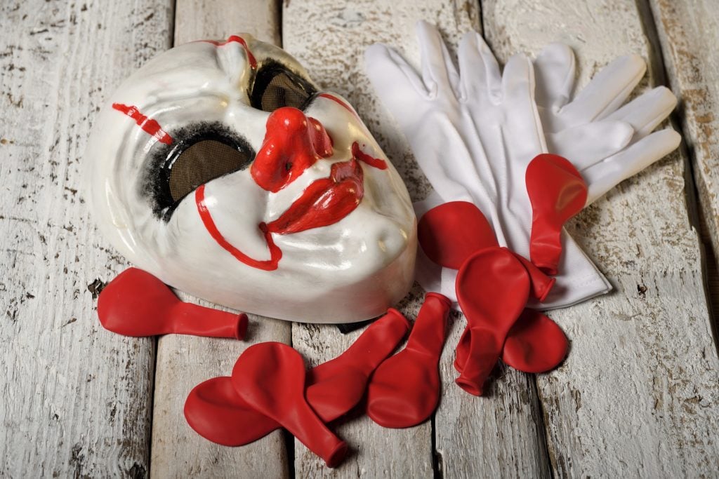 A clown mask lying on the ground