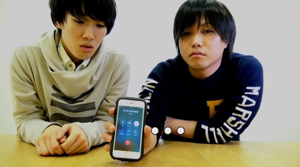 Two Japanese men with a mobile phone