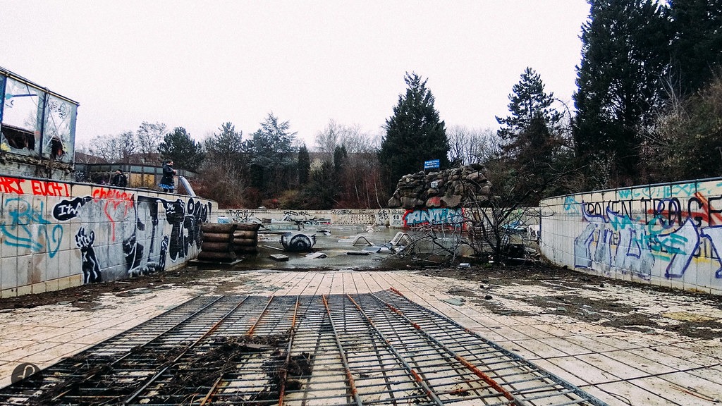 A huge, empty, outdoor swimming pool covered in graffiti at the abandoned Blub water park in Berlin, 2015.