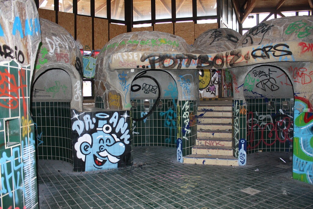 The "water grotto" caves in the main pool at the abandoned Blub water park in Berlin, 2015. The caves are now covered in graffiti. The pool is still empty of water.