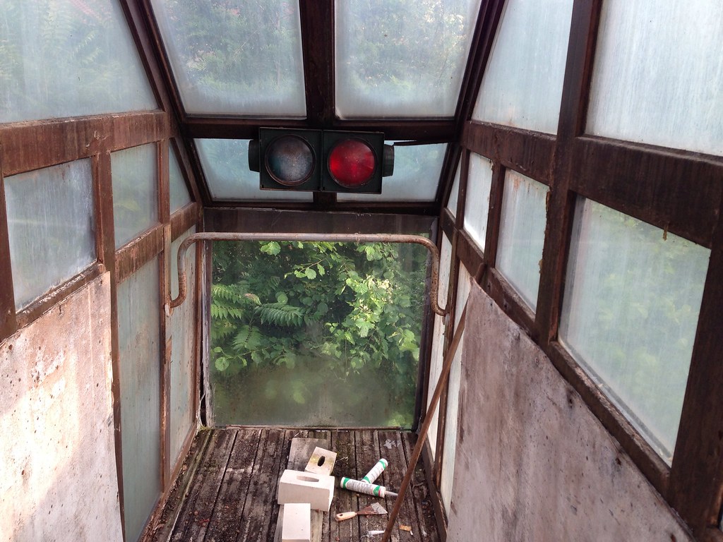 The top of one of the water slides at the abandoned Blub water park in Berlin, 2013. There is a green/red stop light at the top of the opening.