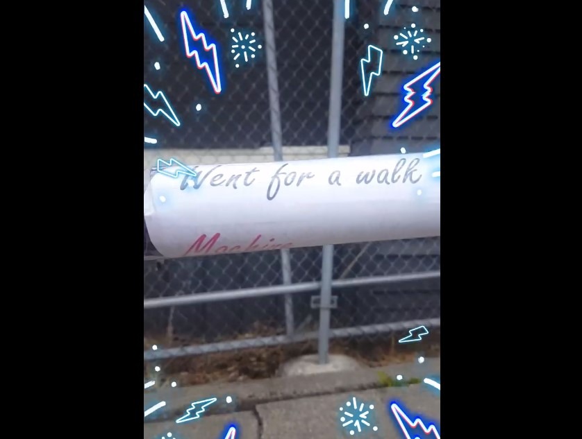 A screenshot from the Mystery Soda Machine's video showing its now-vacant location and its "Went for a walk" sign.