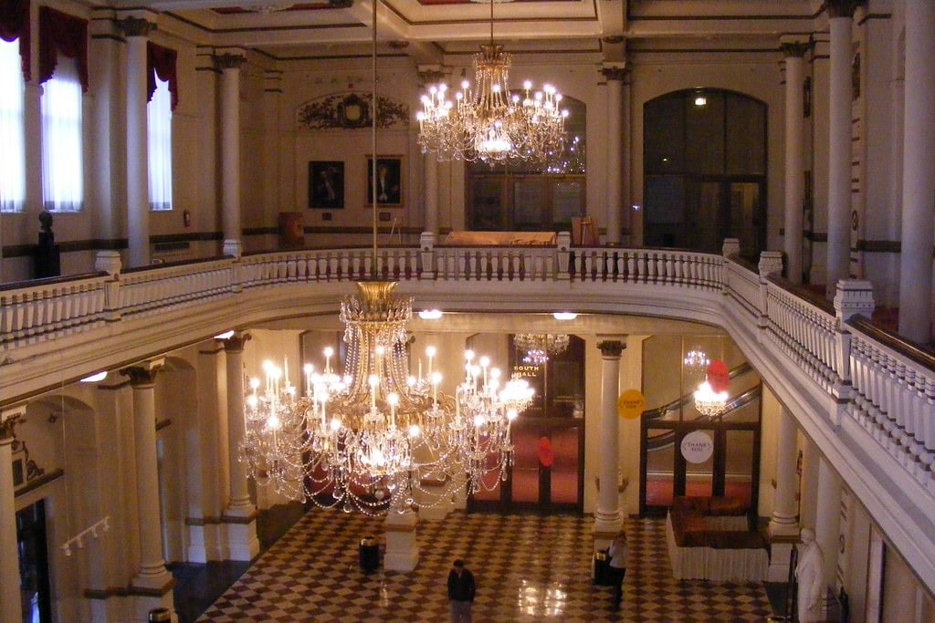 The foyer of Cincinnati Music Hall, with a big, flashy chandelier featured hanging from the ceiling.