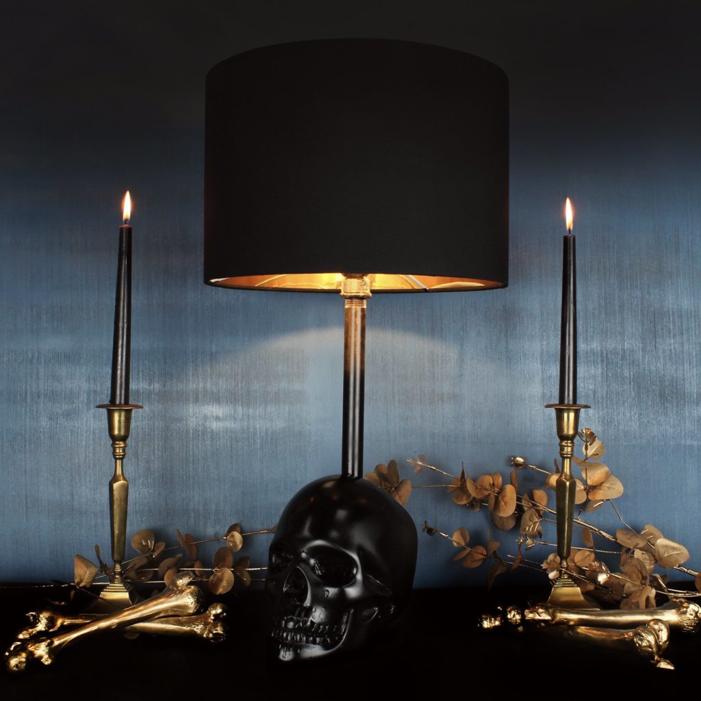 A black table lamp with a skull for the base