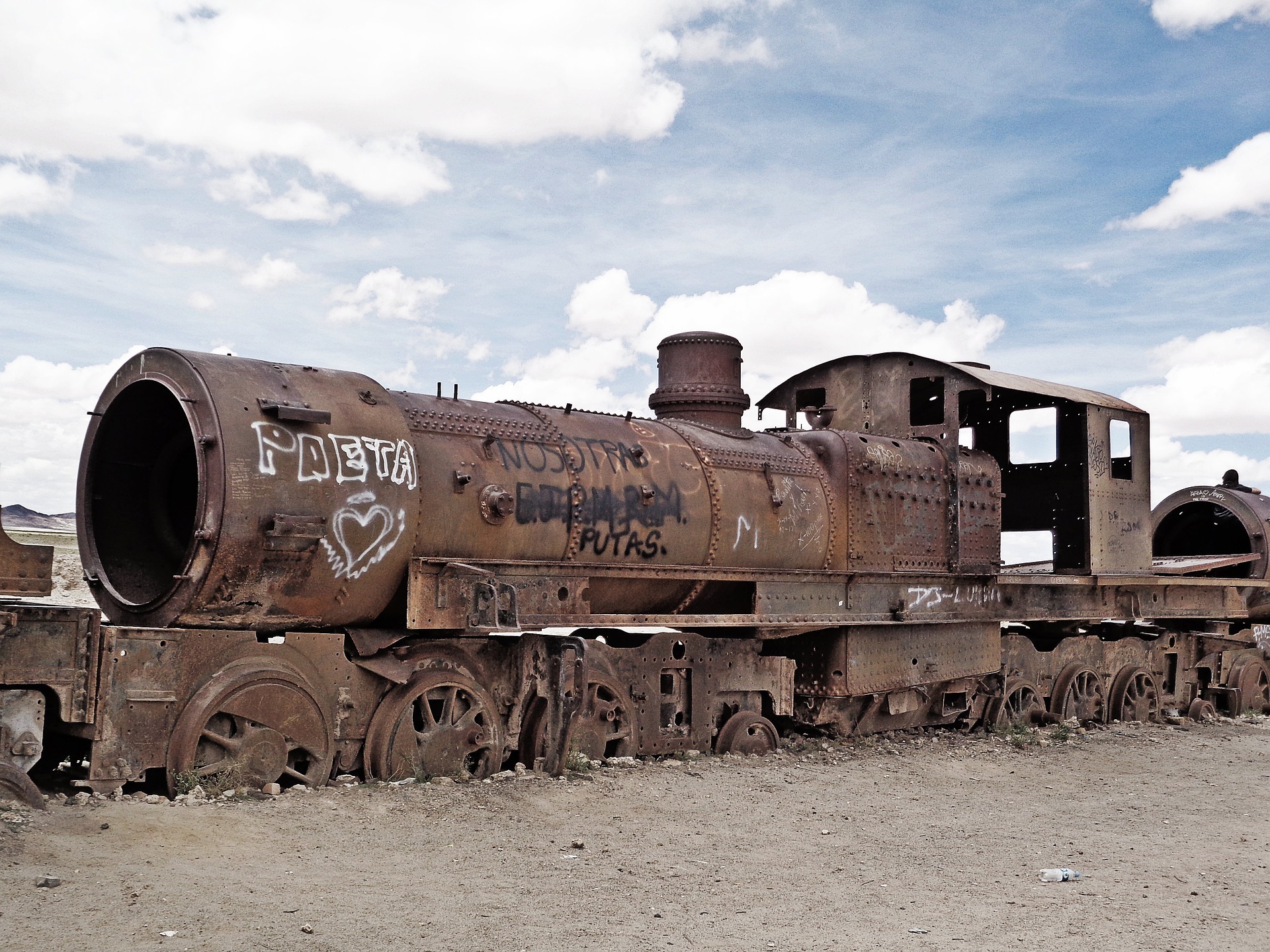 An abandoned train engine in the desert.
