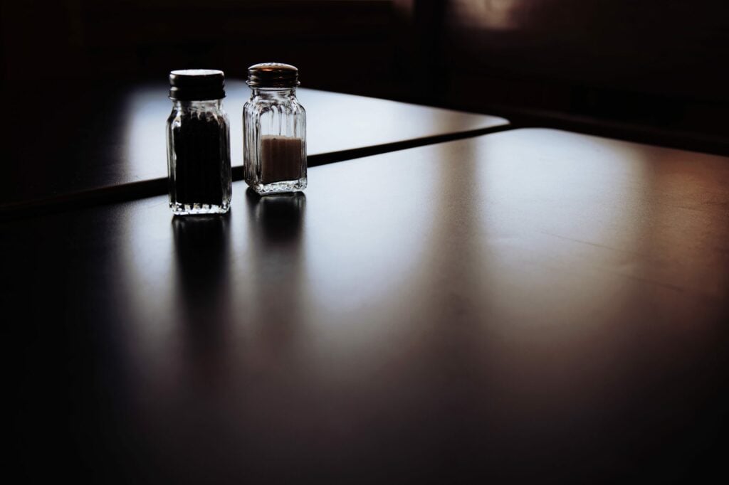 A pair of salt and pepper shakers sitting on a table.