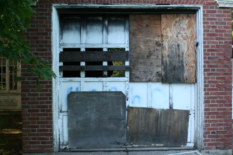 A boarded-up garage door at Fairfield Hills