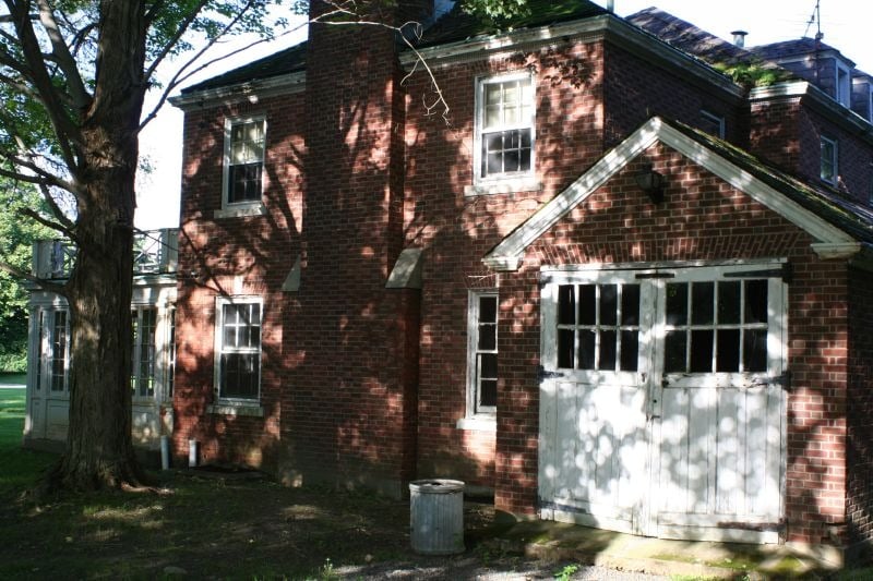 A brick building with white garage doors at Fairfield Hills