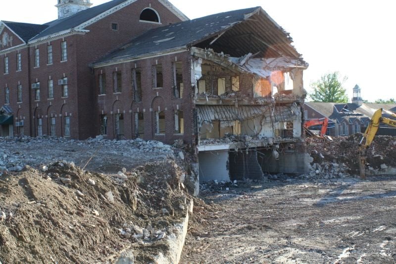 A large, brick building mid-demolition at Fairfield Hills