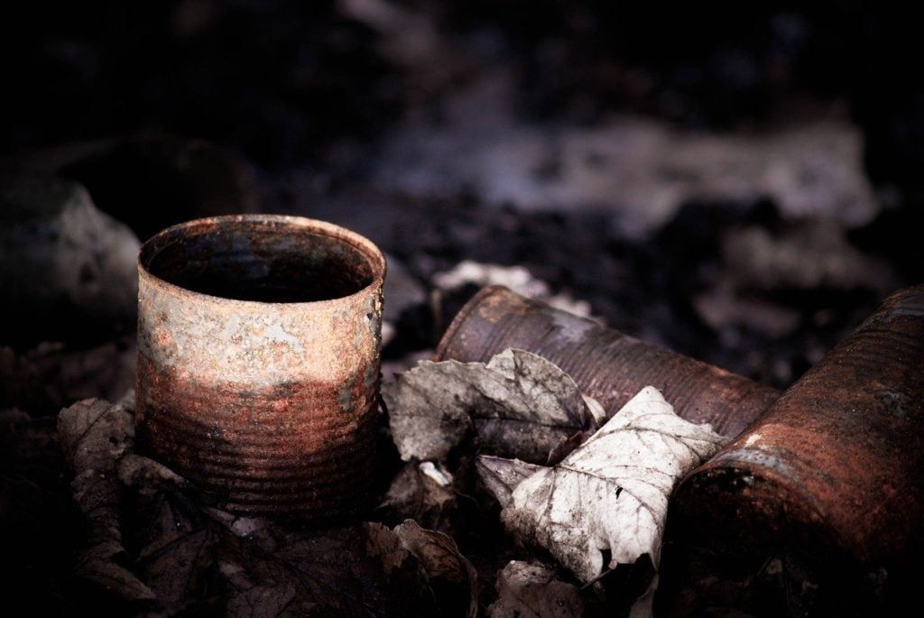 An abandoned, rusting, metal food can