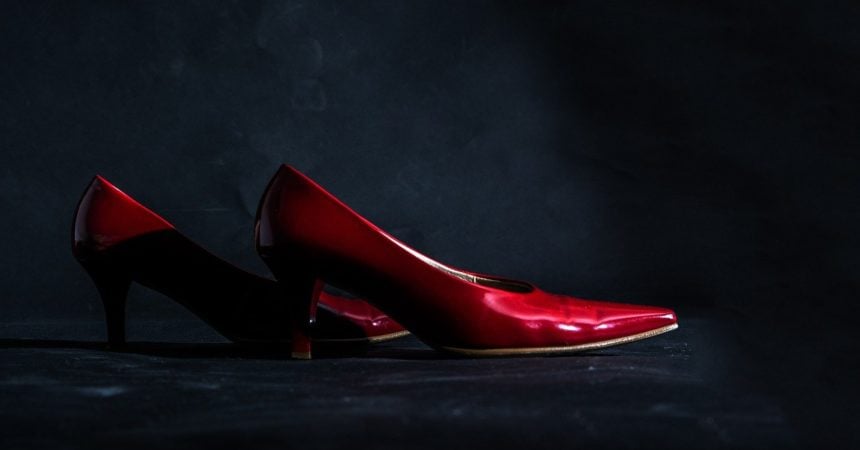 A pair of red high heel shoes in a dark environment